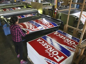 Elections signs roll off the presses at Lakefront Graphix Technology in Mississauga, Ont. on Thursday, Sept. 20. (Veronica Henri/Toronto Sun)
