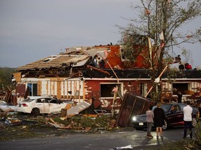 People collect personal effects from damaged homes following a tornado in Dunrobin, Ontario west of Ottawa on Friday, Sept. 21, 2018. A tornado damaged cars in Gatineau, Que., and houses in a community west of Ottawa on Friday afternoon as much of southern Ontario saw severe thunderstorms and high wind gusts, Environment Canada said.