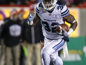 The Argos'' James Wilder Jr. runs the ball against the Stampeders in Calgary on Friday. (Jeff McIntosh /The Canadian Press)