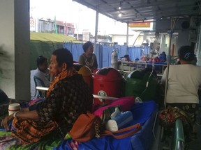 Patients are treated on the hallway of a hospital affected by earthquake in Poso, Central Sulawesi, Indonesia, Saturday, Sept. 29, 2018. A powerful earthquake rocked the Indonesian island of Sulawesi on Friday, triggering a 3-meter-tall (10-foot-tall) tsunami that an official said swept away houses in at least two cities.