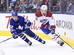 Leafs defenceman Igor Ozhiganov gives chase to Montreal Canadiens defenceman Mike Reilly  during Wednesday's game. (THE CANADIAN PRESS)