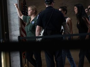 Comedian Amy Schumer is led away after she was arrested during a protest against the confirmation of Supreme Court nominee Judge Brett Kavanaugh October 4, 2018 at the Hart Senate Office Building on Capitol Hill in Washington, D.C.