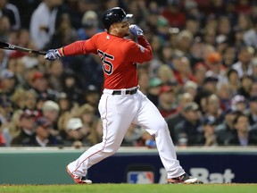 Steve Pearce of the Boston Red Sox hits an RBI single in the third inning against the New York Yankees during Game One of the American League Division Series at Fenway Park on Friday.  (Elsa/Getty Images)