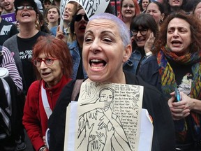 NEW YORK, NY - OCTOBER 06: Meryl Ranzer joins other protesters gathering to demonstrate against Supreme Court Nominee Brett Kavanaugh near Washington Square Park on October 6, 2018 in New York City. Kavanaugh was confirmed today by the Senate with a vote of 50-48.