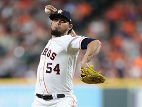 Roberto Osuna #54 of the Houston Astros pitches in the eighth inning against the Boston Red Sox during Game Three of the American League Championship Series at Minute Maid Park on October 16, 2018 in Houston, Texas.