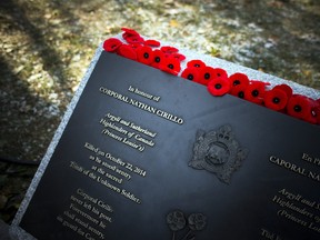 Poppies lay on the monument for Corporal Nathan Cirillo after the National Remembrance Day Ceremony at the National War Memorial in Ottawa on Saturday, November 11, 2017.