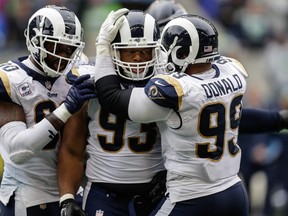 Rams defensive tackle Ndamukong Suh celebrates a sack with teammates on Sunday against the Seahawks. (GETTY IMAGES)