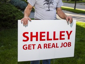 Tony Dundas has put a sign on his front lawn which is critical of candidate Shelley Carroll, a former city councillor. (Ernest Doroszuk, Toronto Sun)