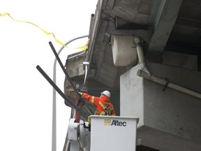 Crews repair the Gardiner Expressway after a pickup truck ran into a stretch of guardrail. (Stan Behal, Toronto Sun)