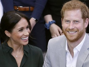Britain's Prince Harry, Duke of Sussex, Meghan, Duchess of Sussex (L) are pictured earlier this month during a visit to Joff Youth Centre in southern England. (Photo by Chris Jackson / POOL / AFP)