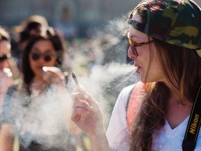 This file photo taken on April 20, 2016 shows a woman smoking during a rally to celebrate National Marijuana Day on Parliament Hill in Ottawa, Canada. (AFP/Getty Images)