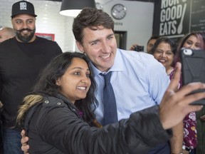 Prime Minister Justin Trudeau poses for a selfie while stopping for lunch at Rick’s Good Eats in Mississauga on Oct. 23. (The Canadian Press)