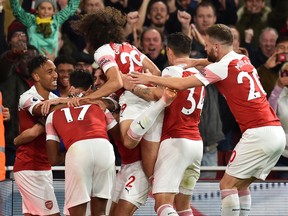 Arsenal's Pierre-Emerick Aubameyang (left) celebrates after scoring against Leicester City on Monday. (GETTY IMAGES)