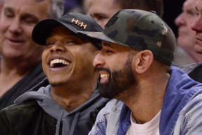 Blue Jays’ Marcus Stroman (left) and former Jay Jose Bautista take in Friday’s game. (THE CANADIAN PRESS)