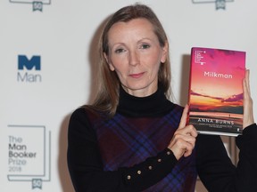 In this file photo taken on Oct. 14, 2018, author Anna Burns holds her book 'Milkman' during a photocall at the Royal Festival Hall in London, ahead of Tuesday's announcement of the winner of the 2018 Man Booker Prize for Fiction. (DANIEL LEAL-OLIVAS/AFP/Getty Images)