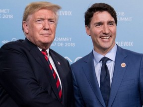 In this file photo taken on June 8, 2018, US President Donald Trump and Canadian Prime Minister Justin Trudeau hold a meeting on the sidelines of the G7 Summit in La Malbaie, Quebec, Canada. - Canadian Prime Minister Justin Trudeau said working with US President Donald Trump is "not always simple," as he welcomed the successful renegotiation of the North American Free Trade Agreement. Speaking on an episode of Quebec's most popular talk show, "Tout Le Monde En Parle," broadcast October 21, 2018 Trudeau said he had done his job of "standing up for Canadians" in agreeing the USMCA trade pact with the US, Canada and Mexico.Asked about his relationship with Trump, Trudeau cautiously acknowledged it is "not always simple."