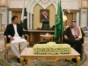 In this handout photograph released by Pakistan's Press Information Department (PID) on October 23, 2018, Saudi King Salman (R) meets with Pakistan's Prime Minister Imran Khan during a meeting in Riyadh. (HANDOUT/AFP/Getty Images)