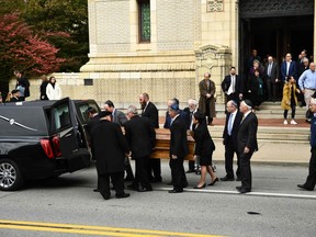 Mourners gather as a casket is carried outside the Rodef Shalom Congregation where the funeral for Tree of Life Congregation mass shooting victims Cecil Rosenthal and David Rosenthal on Tuesday. (BRENDAN SMIALOWSKI/AFP/Getty Images)