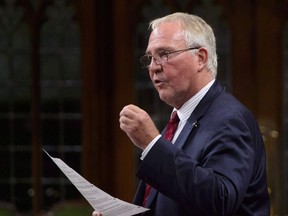 Bill Blair, Minister of Border Security and Organized Crime Reduction, stands during question period in the House of Commons on Parliament Hill in Ottawa on Monday, Sept. 17, 2018. Irregular border crossers being housed temporarily in hotels in Toronto will have their stays extended by four weeks while officials continue to search for a longer-term solution.