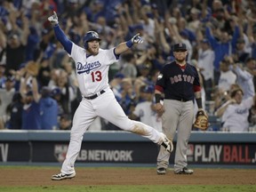 Los Angeles Dodgers' Max Muncy celebrates after his walk off home run against the Boston Red Sox during the 18th inning in Game 3 of the World Series baseball game on Saturday, Oct. 27, 2018, in Los Angeles. (AP Photo/Jae C. Hong)
