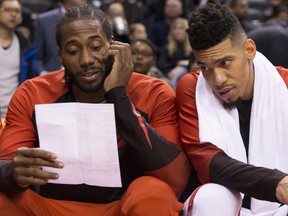 Toronto Raptors' Kawhi Leonard, left, and Danny Green look at a stats sheet during second half exhibition basketball action against Melbourne United, in Toronto on Friday, October 5, 2018. THE CANADIAN PRESS/Chris Young