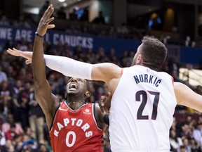 Portland Trail Blazers centre Jusuf Nurkic (27) tries to stop Toronto Raptors forward CJ Miles (0) from scoring a point during pre-season NBA action in, Vancouver, Saturday, Sept, 29, 2018. THE CANADIAN PRESS Jonathan Hayward