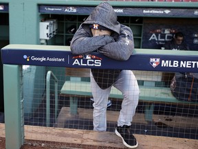 Houston Astros third baseman Alex Bregman leans on the dugout rail as the Boston Red Sox work out at Fenway Park, Friday, Oct. 12, 2018, in Boston. (AP Photo/Elise Amendola)