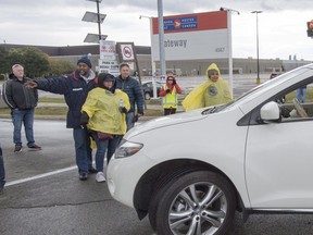 Striking Canada Post workers walk the picket line in Mississauga, Ontario on Tuesday October 23, 2018. THE CANADIAN PRESS/Frank Gunn