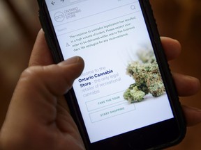 The Ontario Cannabis Store website pictured on a mobile phone Ottawa on Thursday, Oct. 18, 2018. THE CANADIAN PRESS/Sean Kilpatrick