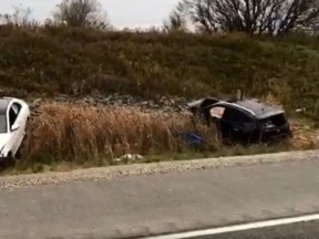 Two vehicles can be seen in a ditch after a deadly alleged drunk driving crash on Hwy. 404 on Friday, Oct. 26, 2018. OPP say the white car hit the black car. (Screengrab from Kerry Schmidt video)