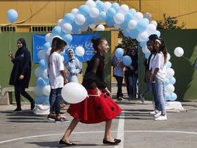 Palestinian refugee students attend a ceremony to mark the return to school of a new year at one of the UNRWA schools, in Beirut, Lebanon, Monday, Sept. 3, 2018. Canada is contributing $50 million to the United Nations Palestinian refugee agency, after the United States decided to stop funding what it called an "irredeemably flawed" organization.