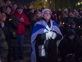 Annette Hkr-Even takes part in Monday's vigil for the Pittsburgh synagogue shooting victims at Mel Lastman Square. (Tijana Martin/The Canadian Press)
