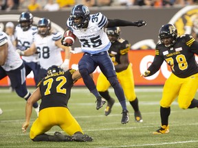 Argos running back Brandon Burks, ripping off a big gain during their exhibition game against the Ticats, will start the team’s final four games, beginning with Friday’s contest at BMO Field against the same Tabbies.  THE CANADIAN PRESS/Peter Power