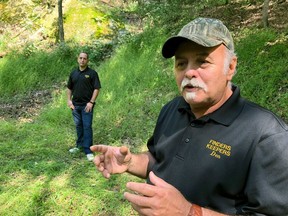 In this Sept. 20, 2018 photo, Dennis Parada, right, and his son Kem Parada stand at the site of the FBI's dig for Civil War-era gold in Dents Run, Pennsylvania.