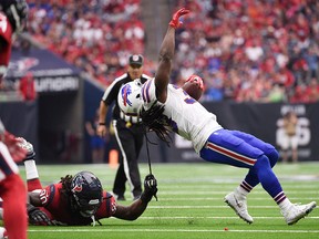 Houston Texans linebacker Jadeveon Clowney pulls Buffalo Bills running back Chris Ivory down by his dreadlocks during the second half of an NFL game, Sunday, Oct. 14, 2018, in Houston.