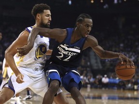 Minnesota Timberwolves' Andrew Wiggins, right, keeps the ball from Golden State Warriors' Klay Thompson (11) during the first half of an NBA preseason basketball game Saturday, Sept. 29, 2018, in Oakland, Calif. (THE CANADIAN PRESS/AP/Ben Margot)