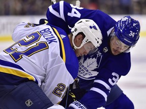 St. Louis Blues centre Tyler Bozak (21) and Toronto Maple Leafs centre Auston Matthews (34) battle for the puck at faceoff during third period NHL action in Toronto on October 20, 2018. (THE CANADIAN PRESS/Frank Gunn)