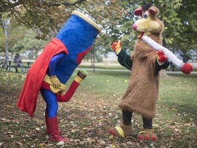 Two costumed figures, including Tokaroo, right, mark the first day of legalization of cannabis across Canada in a Toronto park on Wednesday, October 17, 2018. Mascot maker Mark Scott says he will not buckle to legal threats from Ontario's public broadcaster over his pothead parody of the beloved children's TV character Polkaroo.
