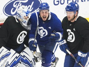 Maple Leafs goaltender Garret Sparks watches as   Auston Matthews (centre) and Morgan Rielly get in his kitchen during Tuesday's practice. (CRAIG ROBERTSON/TORONTO SUN)