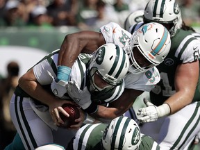 In this Sept. 16, 2018, file photo, Miami Dolphins' Robert Quinn (94) sacks New York Jets' Sam Darnold (14) in East Rutherford, N.J. (AP Photo/Julio Cortez, File)