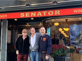 Elton John and David Furnish pose with restaurant manager Allen Gottschalk outside the Senator in Toronto. (Instagram.com/eltonjohn)