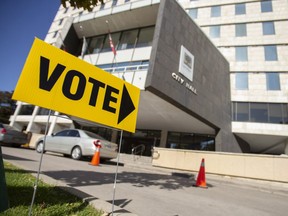 A sign points voters towards a polling station at City Hall in London, Ont., on Monday, October 22, 2018. London is the first municipality to adopt a ranked ballot system in Canada. THE CANADIAN PRESS/Geoff Robins