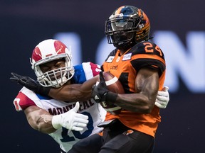 Lions’ Jeremiah Johnson (right) is tackled by the Alouettes’ Henoc Muamba. Muamba has 100 defensive tackles, five sacks, a league-leading 11 tackles for losses, a forced fumble, an interception this season.  Darryl Dyck/The Canadian Press