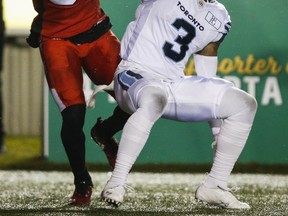Argonauts’ Alden Darby (right) knocks a pass away from theStampeders’ Richard Sindani last weekend.  Darby and the Argos play the Lions tomorrow night.  Jeff McIntosh/CP