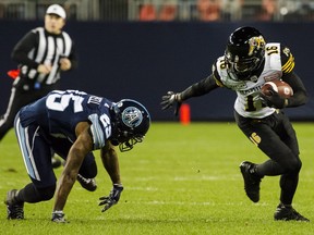 Hamilton Tiger-Cats wide receiver Brandon Banks (16) escapes a tackle from Toronto Argonauts defensive back Ronnie Yell (25) during first half CFL football action in Toronto on Friday, Oct. 12, 2018. THE CANADIAN PRESS/Christopher Katsarov