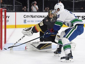 Marc-Andre Fleury of the Vegas Golden Knights knocks the puck away from Brandon Sutter of the Vancouver Canucks at T-Mobile Arena on October 24, 2018 in Las Vegas. (Ethan Miller/Getty Images)