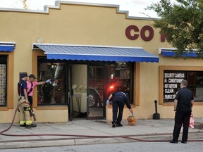 Jacksonville Fire and Rescue personnel use chemicals and hoses to clean the blood outside the Maytag Coin Laundry on A Philip Randolph Boulevard, Sunday, Oct. 21, 2018, in Jacksonville, Fla., after a street shooting earlier in the day, several blocks away from TIAA Bank Field where the Jacksonville Jaguars and Houston Texans played an NFL football game.