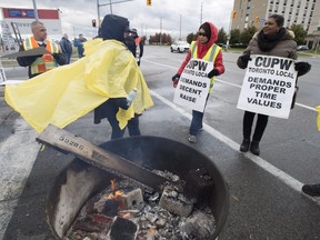 Striking Canada Post workers walk the picket line in Mississauga, Ontario on Tuesday October 23, 2018. THE CANADIAN PRESS/Frank Gunn