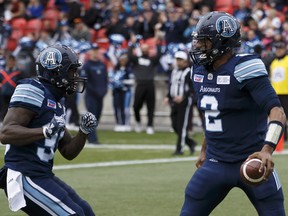 Argonauts quarterback James Franklin (right celebrates his touchdown with teammate Brandon Burks against the Montreal Alouettes, on Oct. 20. (Cole Burston/The Canadian Press)