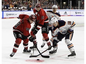 Cologne's Colby Genoway, left, and Oiler's Ryan Strome fight for the puck during game between Koelner Haie (Cologne Sharks) and the Edmonton Oilers in Cologne, Germany, Wednesday, Oct. 3, 2018.